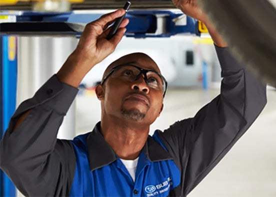 Subaru technician checking vehicle