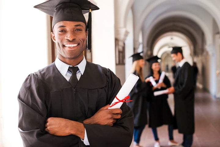 college graduate holding his diploma | Dellenbach Subaru in Fort Collins CO